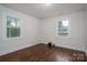 Bedroom features wood floors, white trim, and windows with backyard views at 201 Lee Black Rd, Cherryville, NC 28021