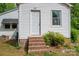 Rear entry featuring a white door, brick steps and a covered awning at 201 Lee Black Rd, Cherryville, NC 28021