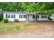 A cozy one-story home with a chimney, black shutters, and a covered front porch at 201 Lee Black Rd, Cherryville, NC 28021