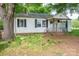 Charming one-story home with a covered front porch, black shutters, and mature trees at 201 Lee Black Rd, Cherryville, NC 28021