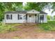 Quaint white home with black shutters and a small, iron-railed front porch at 201 Lee Black Rd, Cherryville, NC 28021