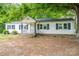 Charming white home with black shutters and an intricate iron-railed front porch at 201 Lee Black Rd, Cherryville, NC 28021