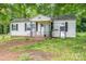 White home featuring a black-iron-railed porch and black shutters on the windows at 201 Lee Black Rd, Cherryville, NC 28021