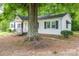 Side view of a white home with black shutters and an iron-railed front porch at 201 Lee Black Rd, Cherryville, NC 28021