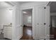Hallway view featuring wood floors, white trim and entryways to bathroom and bedroom at 201 Lee Black Rd, Cherryville, NC 28021