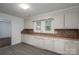 Kitchen featuring wood counters, tiled back splash, stainless steel sink and white cabinets at 201 Lee Black Rd, Cherryville, NC 28021