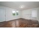 Bright living room featuring a fireplace, two windows that let in natural light, and hardwood flooring at 201 Lee Black Rd, Cherryville, NC 28021
