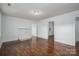 Bright living room features beautiful hardwood floors, white walls, fireplace, and an open doorway at 201 Lee Black Rd, Cherryville, NC 28021