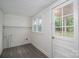 Bright mud room with white paneled walls, grey vinyl flooring, and door to exterior at 201 Lee Black Rd, Cherryville, NC 28021