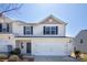 Inviting two-story townhouse with a two-car garage, neutral siding, and well-maintained landscaping at 2035 Talbert Ct, Charlotte, NC 28214