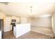 Bright, modern kitchen featuring white cabinets, granite countertops, and stainless steel appliances at 2035 Talbert Ct, Charlotte, NC 28214