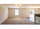 Carpeted living room with a sliding glass door to the backyard and an adjacent kitchen at 2035 Talbert Ct, Charlotte, NC 28214