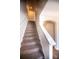 Carpeted staircase with white railing and archway at 2035 Talbert Ct, Charlotte, NC 28214