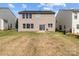 Back view of a home with a spacious backyard, including a patio perfect for outdoor entertaining at 2319 Arbor Vista Dr, Charlotte, NC 28262