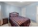 Comfortable bedroom with blue walls, neutral carpet, and dark wood furniture in a cozy and well-lit space at 2319 Arbor Vista Dr, Charlotte, NC 28262