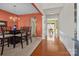 Elegant dining room with modern chandelier, beautiful hardwood floors leading into other parts of the home at 2319 Arbor Vista Dr, Charlotte, NC 28262