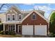 Charming two-story home featuring a combination of brick and siding, complemented by a well-maintained front lawn and landscaping at 2319 Arbor Vista Dr, Charlotte, NC 28262