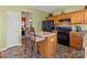 A kitchen with an island and stools, black appliances, and green walls that create an inviting atmosphere at 2319 Arbor Vista Dr, Charlotte, NC 28262
