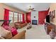 Inviting living room with a cozy fireplace, ceiling fan, and large windows that let in ample natural light at 2319 Arbor Vista Dr, Charlotte, NC 28262