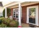 A welcoming porch area featuring brick columns, ample natural light, and seating, perfect for enjoying the outdoors at 2319 Arbor Vista Dr, Charlotte, NC 28262