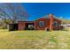 The exterior view of a brick house with a spacious backyard and large tree providing shade to the yard at 260 Trexler Ln, Rock Hill, SC 29732