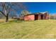 View of a backyard with a storage shed and a large lawn area with a small utility shed and boat in background at 260 Trexler Ln, Rock Hill, SC 29732