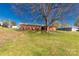 Expansive backyard featuring green grass, mature trees, and outbuildings offers a serene and private outdoor space at 260 Trexler Ln, Rock Hill, SC 29732
