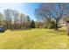 Expansive backyard with lush green grass and mature trees offers a serene and private outdoor space at 260 Trexler Ln, Rock Hill, SC 29732