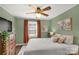 Comfortable bedroom with a ceiling fan, warm-toned curtains, and a dresser, creating a cozy and inviting retreat at 260 Trexler Ln, Rock Hill, SC 29732