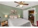 Relaxing bedroom featuring a ceiling fan, neutral color scheme, and an adjacent view into the well-lit kitchen area at 260 Trexler Ln, Rock Hill, SC 29732
