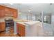 Open kitchen featuring a breakfast bar, and stainless steel appliances overlooking the living area with fireplace at 329 Northwest Dr, Davidson, NC 28036