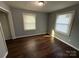 Well-lit bedroom featuring neutral walls and hardwood flooring at 3316 Queens Ln # 10, Gastonia, NC 28052
