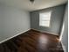 Sunlit bedroom with hardwood flooring and neutral walls at 3316 Queens Ln # 10, Gastonia, NC 28052