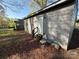 Exterior view with gray siding, a white door, and small wood porch and overgrown brown lawn at 3316 Queens Ln # 10, Gastonia, NC 28052