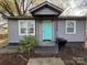 Charming home featuring a vibrant blue front door and gray siding at 3316 Queens Ln # 10, Gastonia, NC 28052