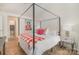 Stylish bedroom featuring a modern canopy bed, wood floors, and bright accents at 336 Northwest Dr, Davidson, NC 28036