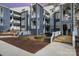 Beautiful condominium exterior showcasing blue siding, white trim, and well-maintained landscaping at 336 Northwest Dr, Davidson, NC 28036