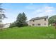 Spacious backyard featuring a well-maintained lawn, mature trees, and partial fencing at 3725 Catawba Creek Dr, Gastonia, NC 28056