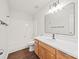 Bright bathroom with a tub and shower combo, wood cabinets, and a large mirror at 3725 Catawba Creek Dr, Gastonia, NC 28056