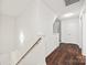 Hallway with a wood staircase and hardwood floors leading to other rooms in the house at 3725 Catawba Creek Dr, Gastonia, NC 28056