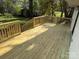 Wide shot of the back deck with wooden railings and steps, ready for outdoor enjoyment at 3735 Stonehaven Dr, Charlotte, NC 28215