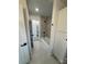 Bright bathroom features modern gray marbled tiling in the shower and white shaker cabinetry for storage at 3735 Stonehaven Dr, Charlotte, NC 28215
