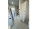 Bright bathroom features modern gray marbled tiling in the shower and white shaker cabinetry for storage at 3735 Stonehaven Dr, Charlotte, NC 28215