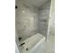 Modern bathroom shower with marbled tile, black fixtures, and a tiled shower niche at 3735 Stonehaven Dr, Charlotte, NC 28215