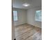 Bright bedroom with wood flooring, two windows and white walls at 3735 Stonehaven Dr, Charlotte, NC 28215