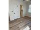 Bright bedroom with wood floors next to a doorway with a stained glass bathroom at 3735 Stonehaven Dr, Charlotte, NC 28215