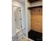 Mud room including black shelving, wood paneling, and a bench for seating at 3735 Stonehaven Dr, Charlotte, NC 28215