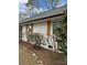 Side view of the home with fresh landscaping, shutters, white painted brick and new roof at 3735 Stonehaven Dr, Charlotte, NC 28215