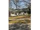 Charming home featuring a freshly painted white brick exterior, new roof, and well-maintained lawn at 3735 Stonehaven Dr, Charlotte, NC 28215