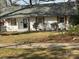 Charming home featuring a freshly painted white brick exterior, new roof, and well-maintained lawn at 3735 Stonehaven Dr, Charlotte, NC 28215
